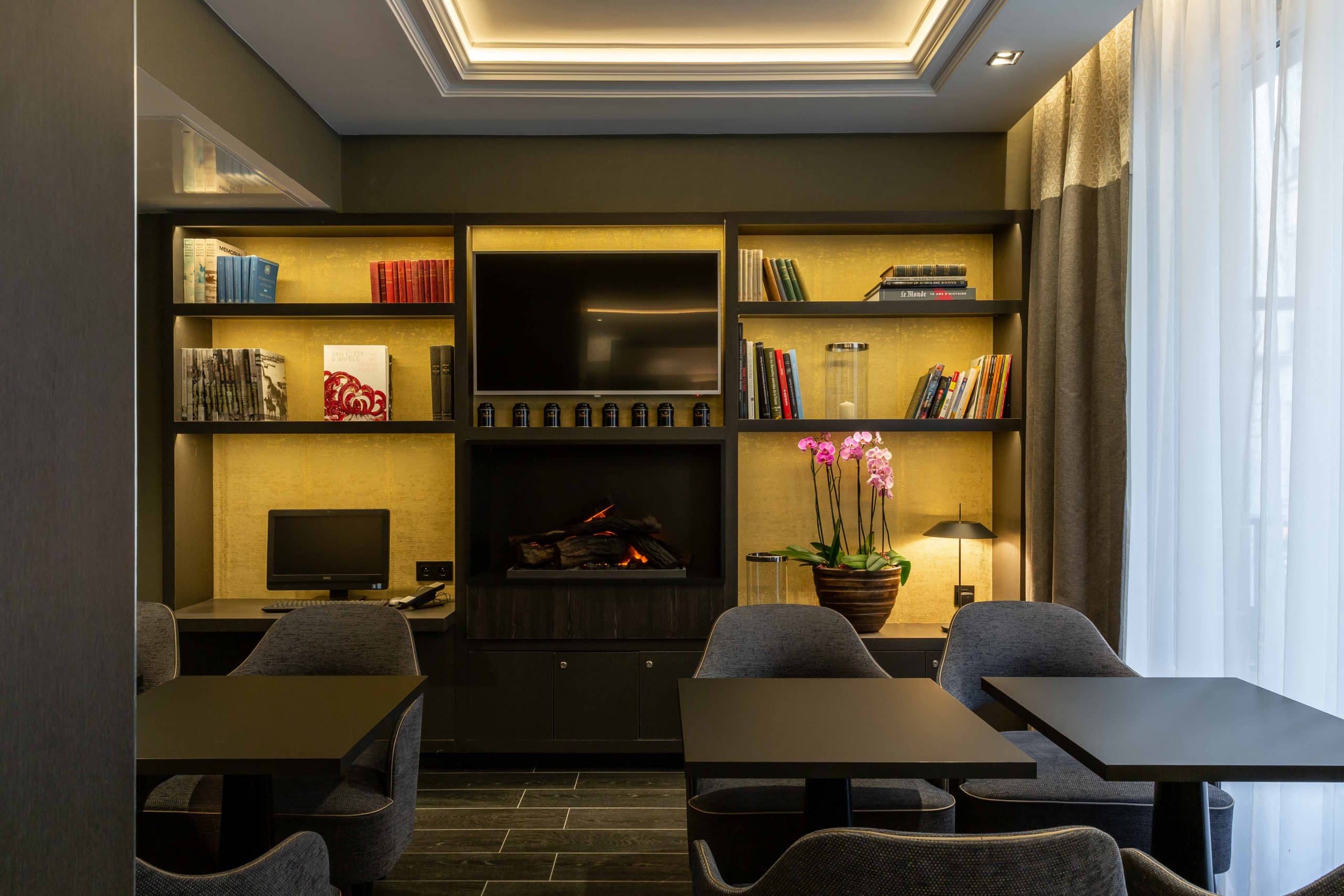 Salle commune de l'Hôtel Daunou Opéra aménagée pour le travail, tables et assises